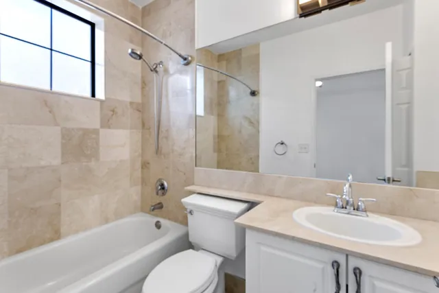 a bathroom with a sink toilet tub and shower
