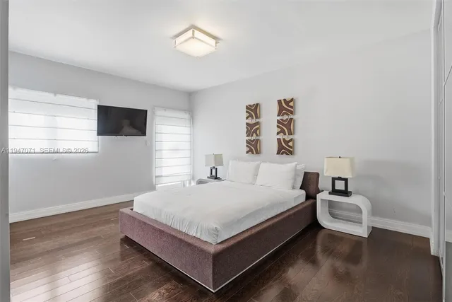 a bathroom with a granite countertop sink two mirror and shower