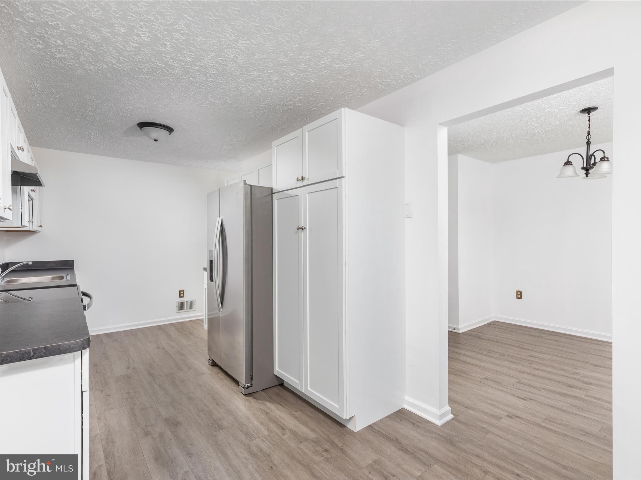 321 Sherando Circle Stephens City, VA 22655 - Photo 13 of 34 a view of an empty room with wooden floor and a cabinet
