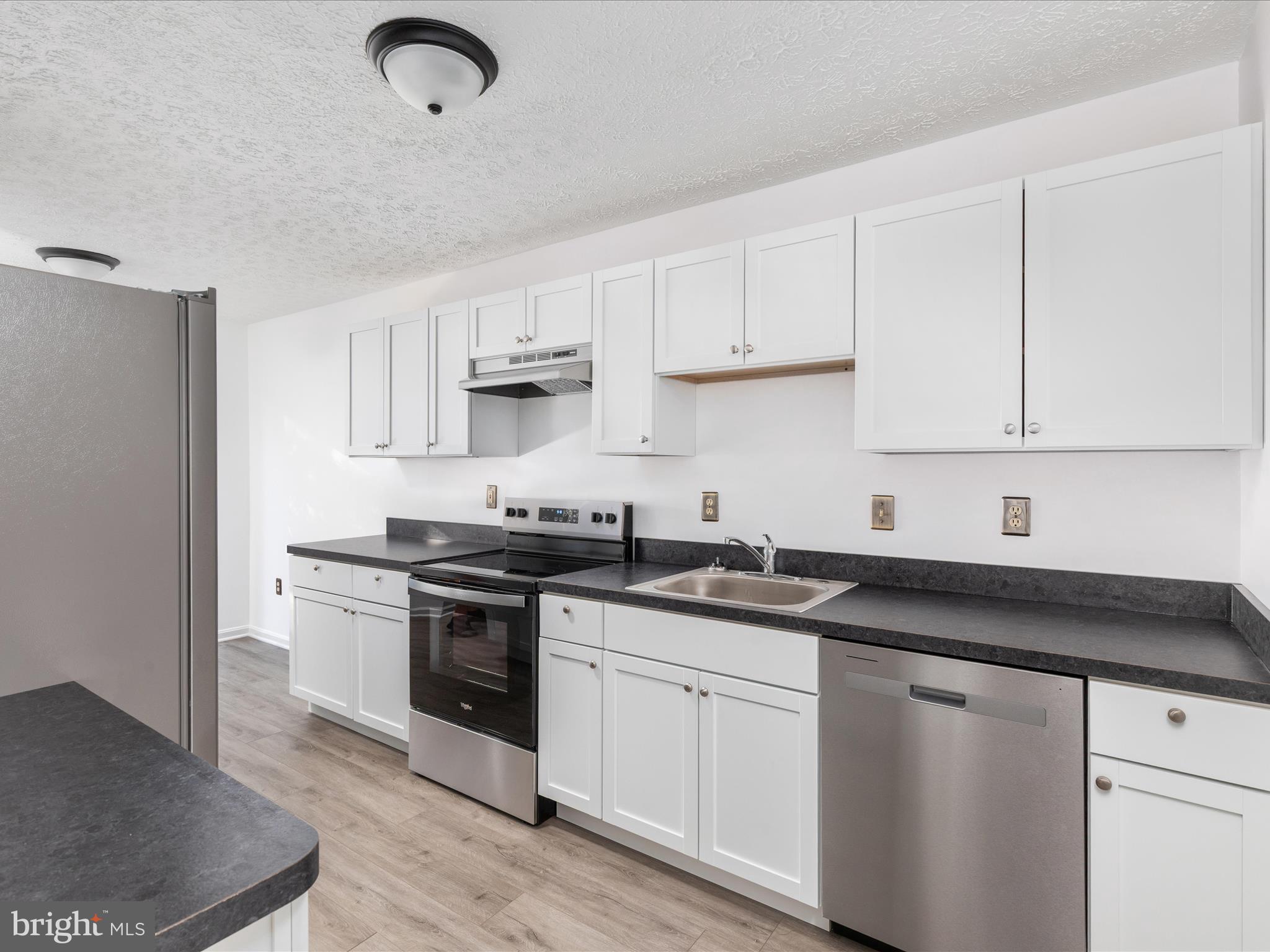 321 Sherando Circle Stephens City, VA 22655 - Photo 15 of 34 a kitchen with stainless steel appliances granite countertop a sink stove and white cabinets