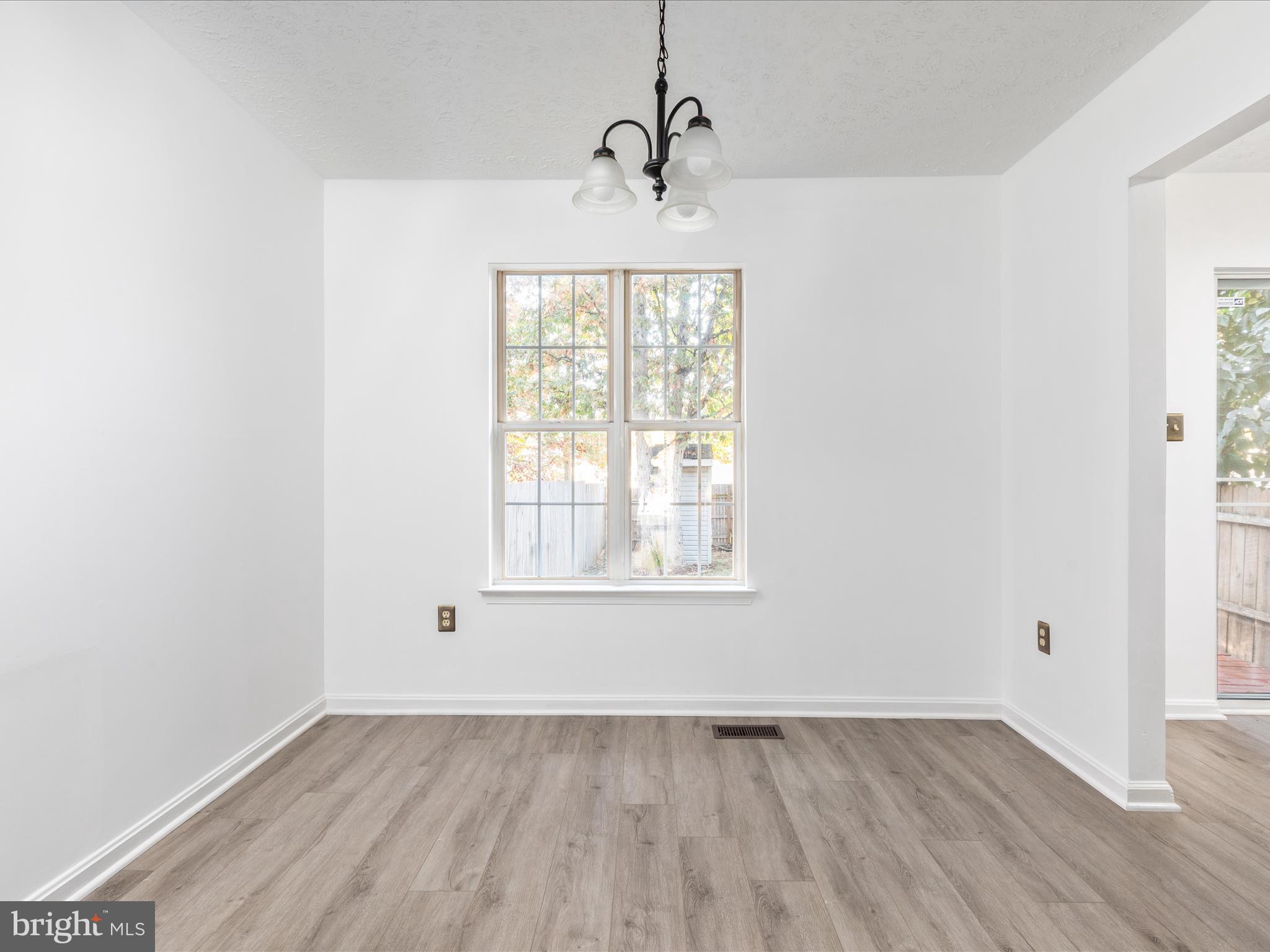 321 Sherando Circle Stephens City, VA 22655 - Photo 8 of 34 an empty room with wooden floor and windows