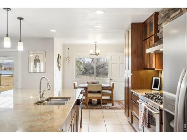 a kitchen view with a sink and wooden floor