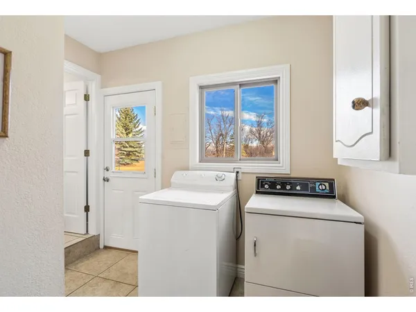 a utility room with dryer washer and a window
