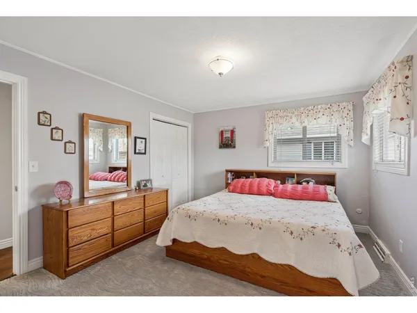 a bedroom with a bed and a large mirror