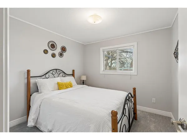 a bedroom with a bed and a painting on the wall