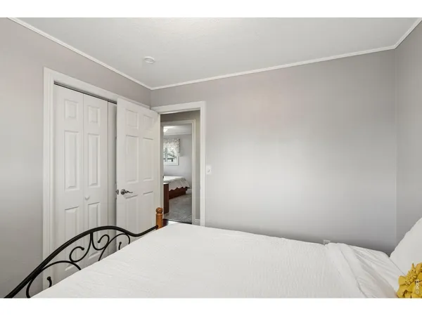 a bedroom with a bed and cabinets