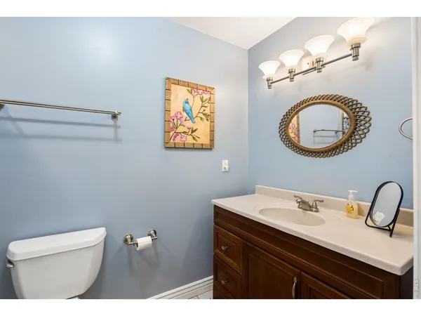 a bathroom with a sink mirror vanity and toilet