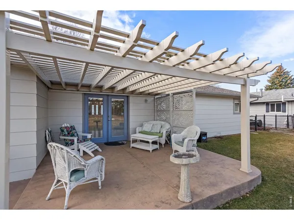 a view of a patio with a table and chairs