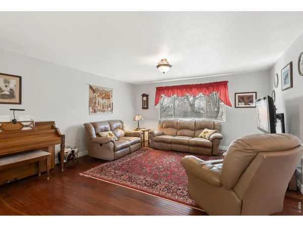 a living room with furniture a couch and a window