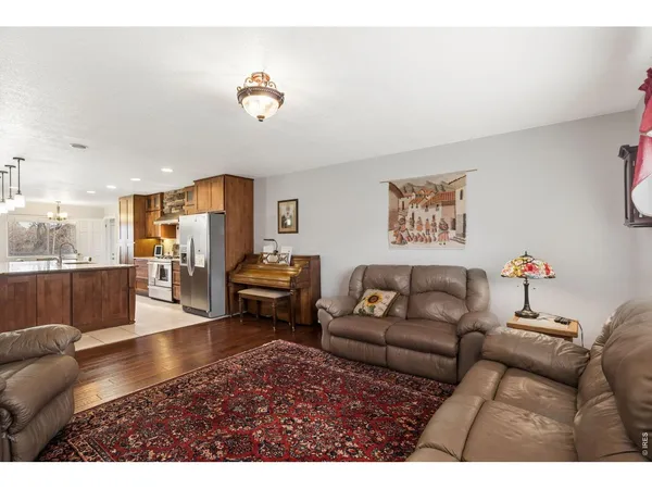 a living room with furniture and kitchen view