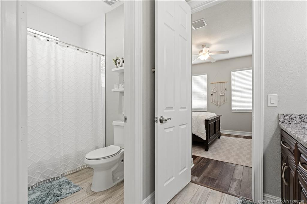 1268 Southeast Kirk Street Stuart, FL 34997 - Photo 42 of 63 a bathroom with a toilet and a shower