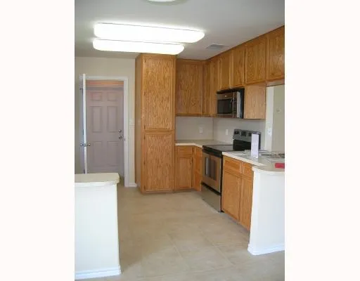 a kitchen with a refrigerator sink and microwave