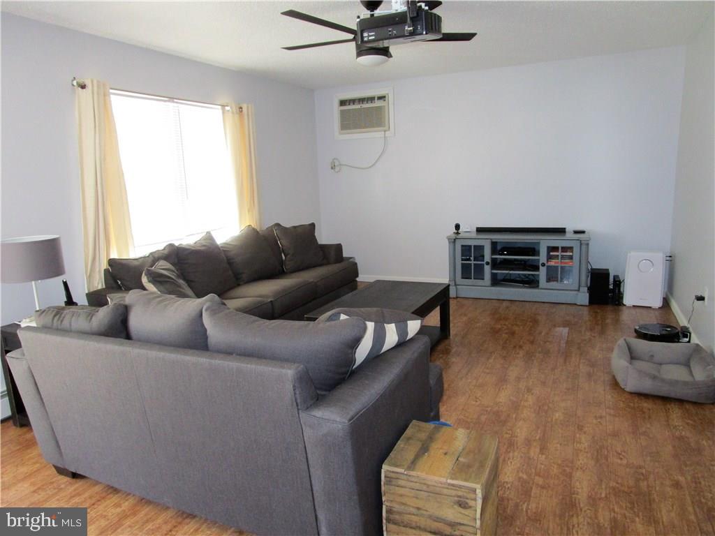 156 Dolphin Road Manahawkin, NJ 08050 - Photo 3 of 9 a living room with furniture and a flat screen tv