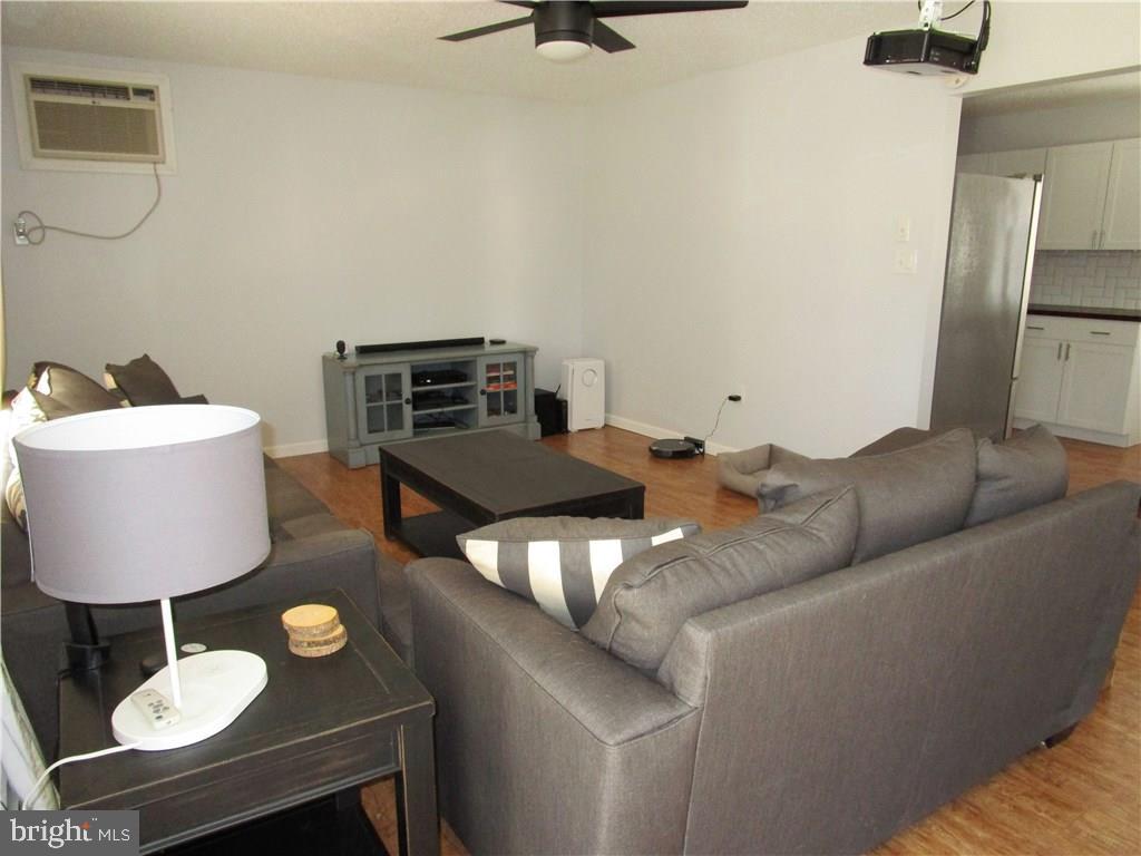 156 Dolphin Road Manahawkin, NJ 08050 - Photo 4 of 9 a living room with furniture and a wooden floor