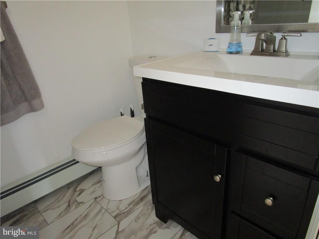 156 Dolphin Road Manahawkin, NJ 08050 - Photo 5 of 9 a bathroom with a sink and a toilet