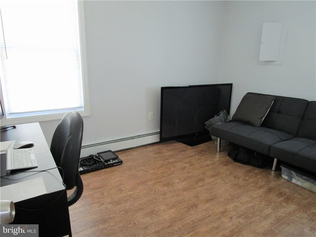 156 Dolphin Road Manahawkin, NJ 08050 - Photo 6 of 9 a bedroom with furniture and a desk