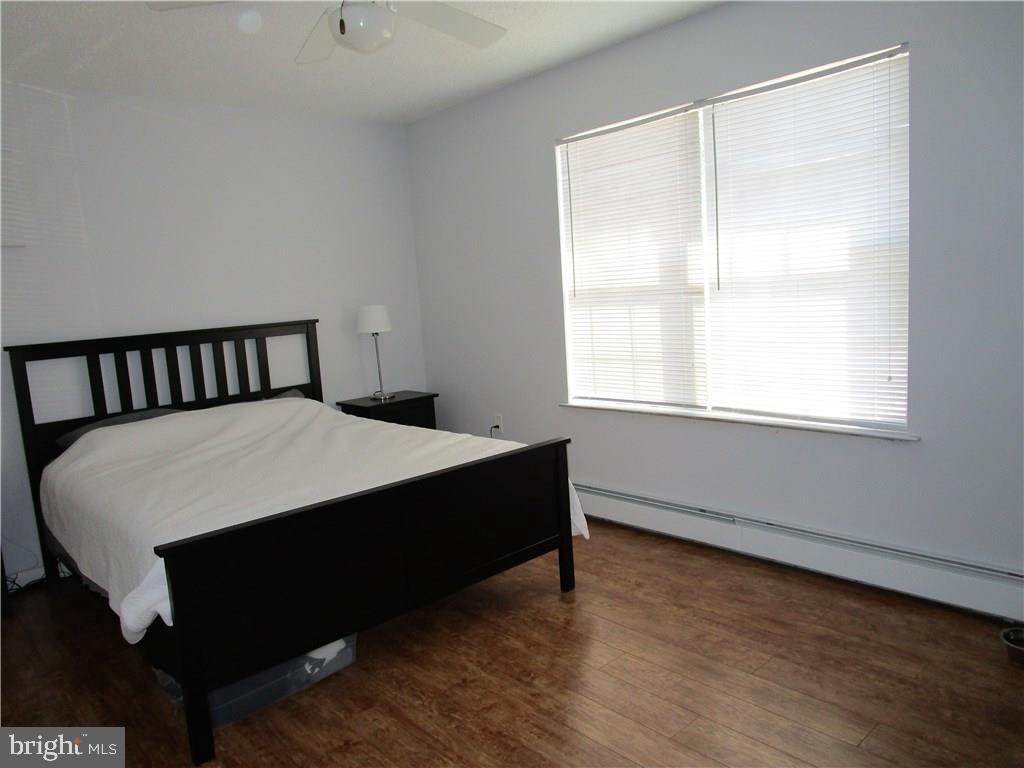 156 Dolphin Road Manahawkin, NJ 08050 - Photo 7 of 9 a large bed sitting in a bedroom next to a window