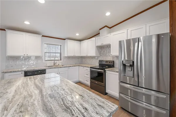 a kitchen with granite countertop stainless steel appliances and wooden cabinets