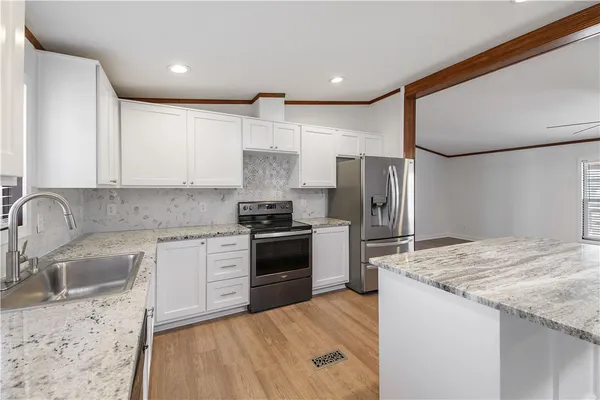 a kitchen with a sink stove and refrigerator