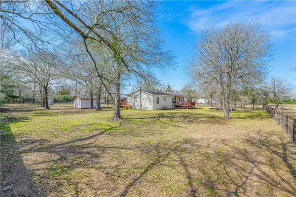 a view of yard with swimming pool
