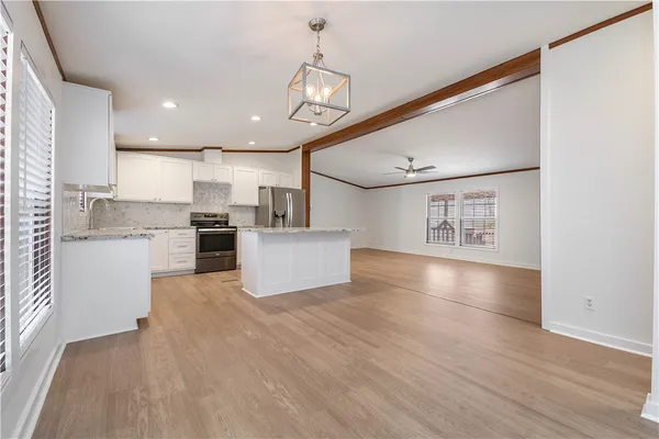 a view of kitchen with cabinets and wooden floor
