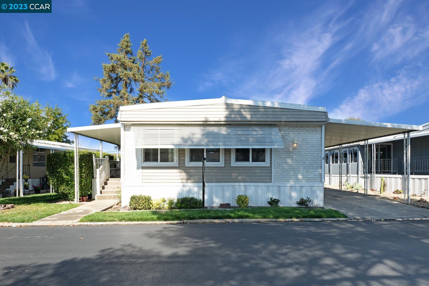 a front view of a house with a garden