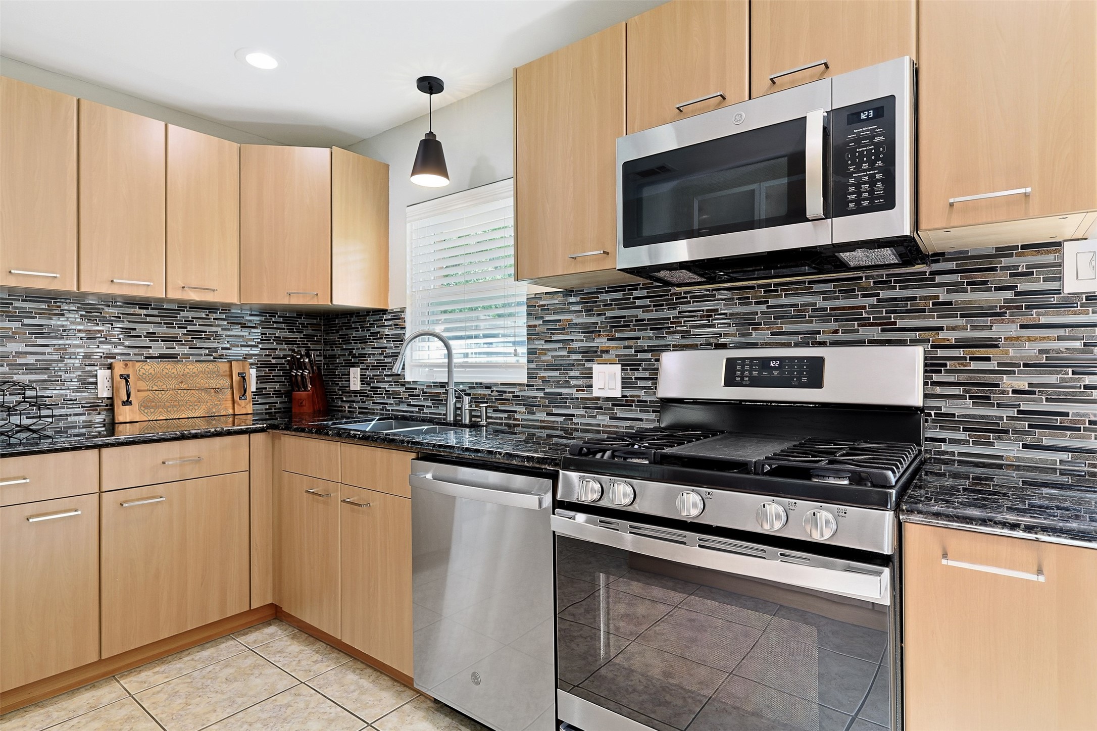 2015 Woodcrest Drive Houston, TX 77018 - Photo 11 of 30 The kitchen includes a gas stove and built-in microwave.