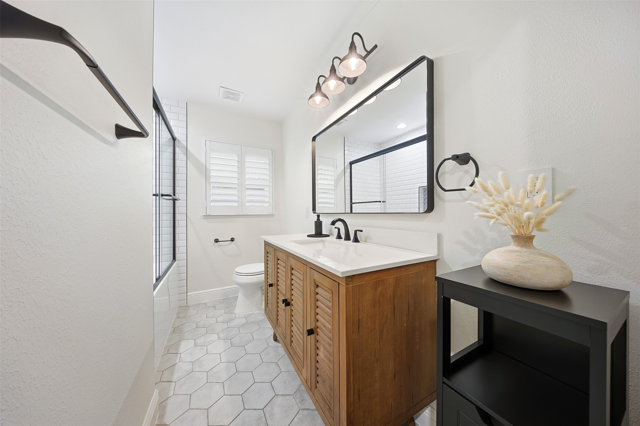 2015 Woodcrest Drive Houston, TX 77018 - Photo 18 of 30 Designer finishes include white marble vanity and hexagonal floor tiles.