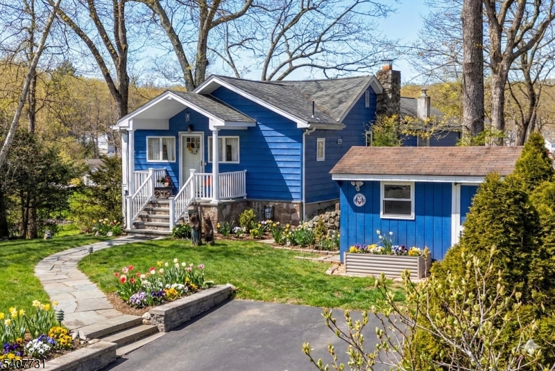 7 Birch Road Bloomingdale, NJ 07403 - Photo 1 of 45 a front view of a house with garden