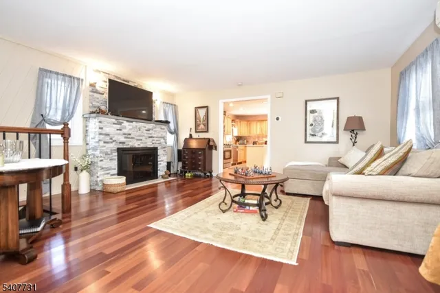 an empty room with wooden floor and large trees