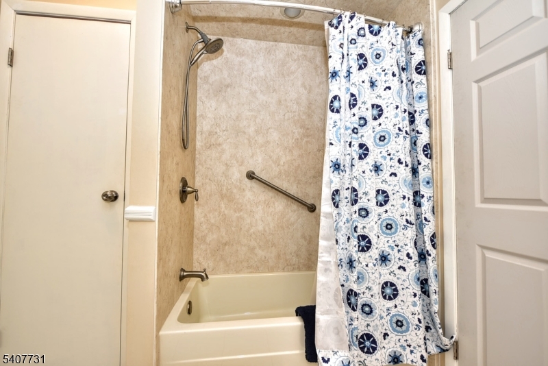 7 Birch Road Bloomingdale, NJ 07403 - Photo 23 of 45 a bathroom with a shower curtain and a shower curtain