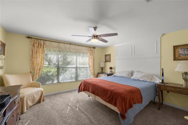 a spacious bedroom with a bed and a large window