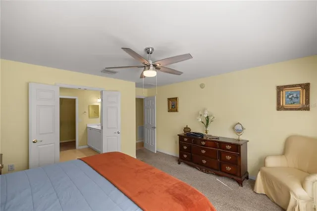 a bedroom with a bed and a ceiling fan