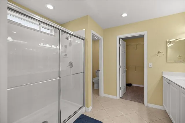a bathroom with a glass shower door and a sink