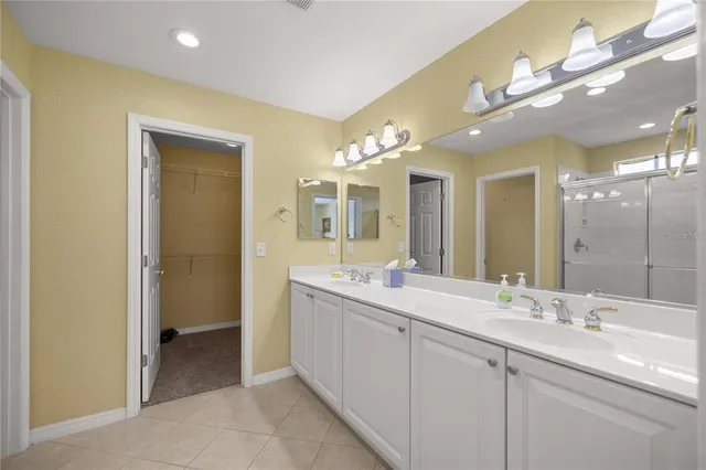 a bathroom with a double vanity sink and a mirror