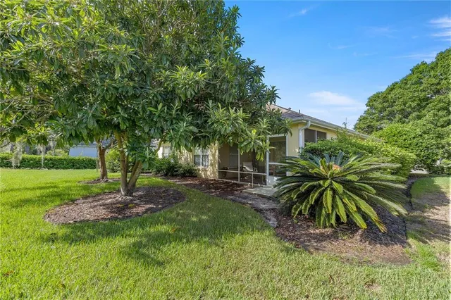 a backyard of a house with table and chairs