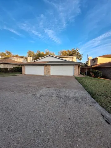 a view of a house with a backyard and a car