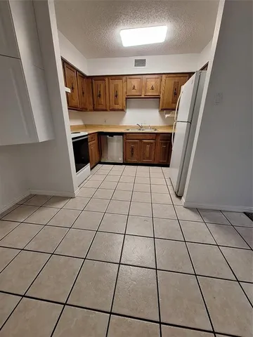 a kitchen with stainless steel appliances a sink and cabinets