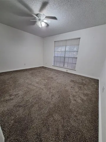 a view of a livingroom with a ceiling fan and window
