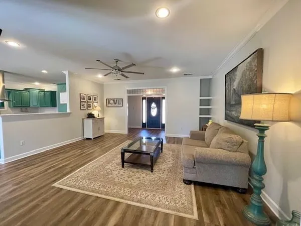 a living room with furniture window and wooden floor