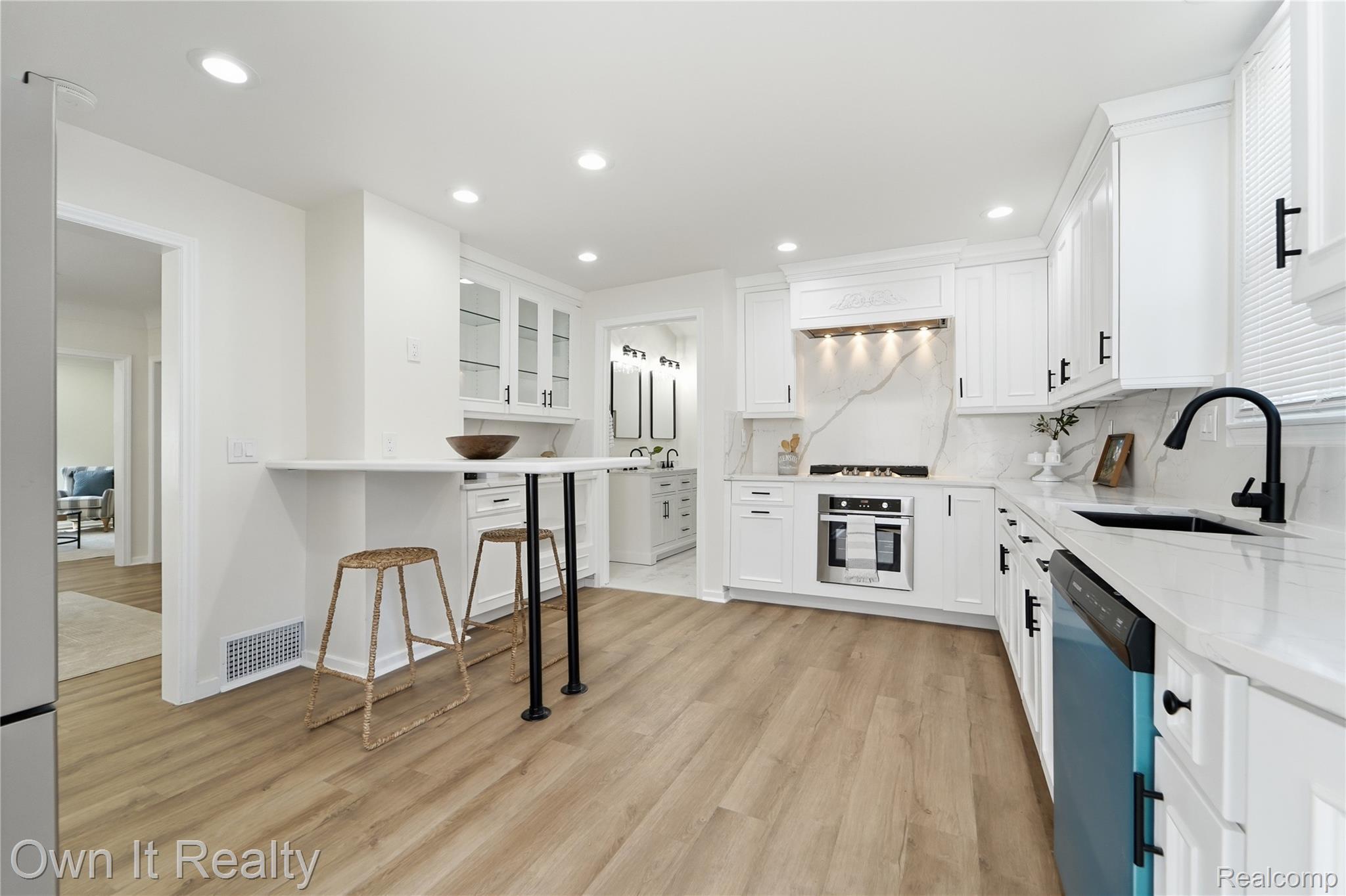 168 Kerby Road Grosse Pointe, MI 48236 - Photo 7 of 36 Contemporary kitchen with white cabinetry, wood-finish flooring, recessed lighting, and a built-in oven