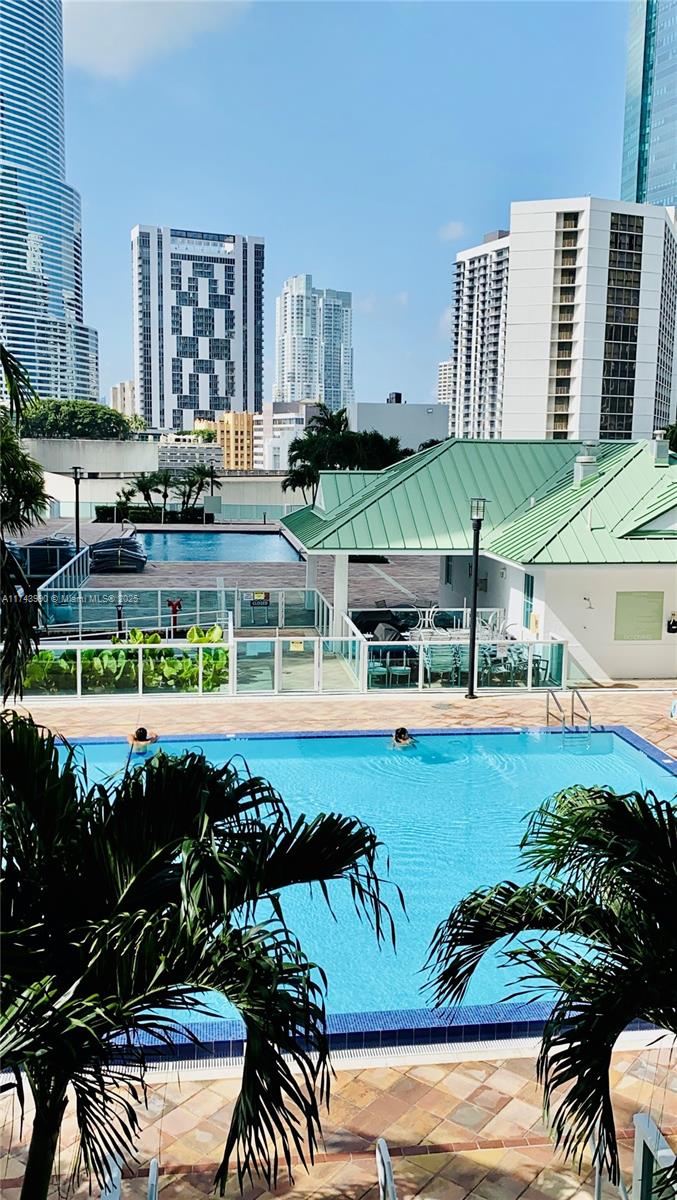 41 Southeast 5th Street, Unit 808 Miami, FL 33131 - Photo 35 of 39 a view of a swimming pool with outdoor seating and plants