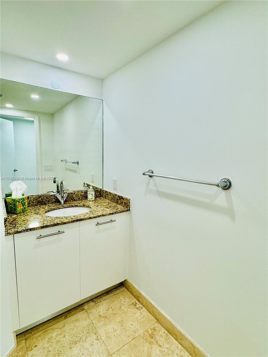 41 Southeast 5th Street, Unit 808 Miami, FL 33131 - Photo 8 of 39 a bathroom with a sink and a mirror