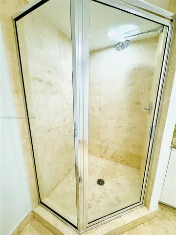 a bathroom with a glass shower door