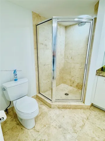 a bathroom with a toilet and shower