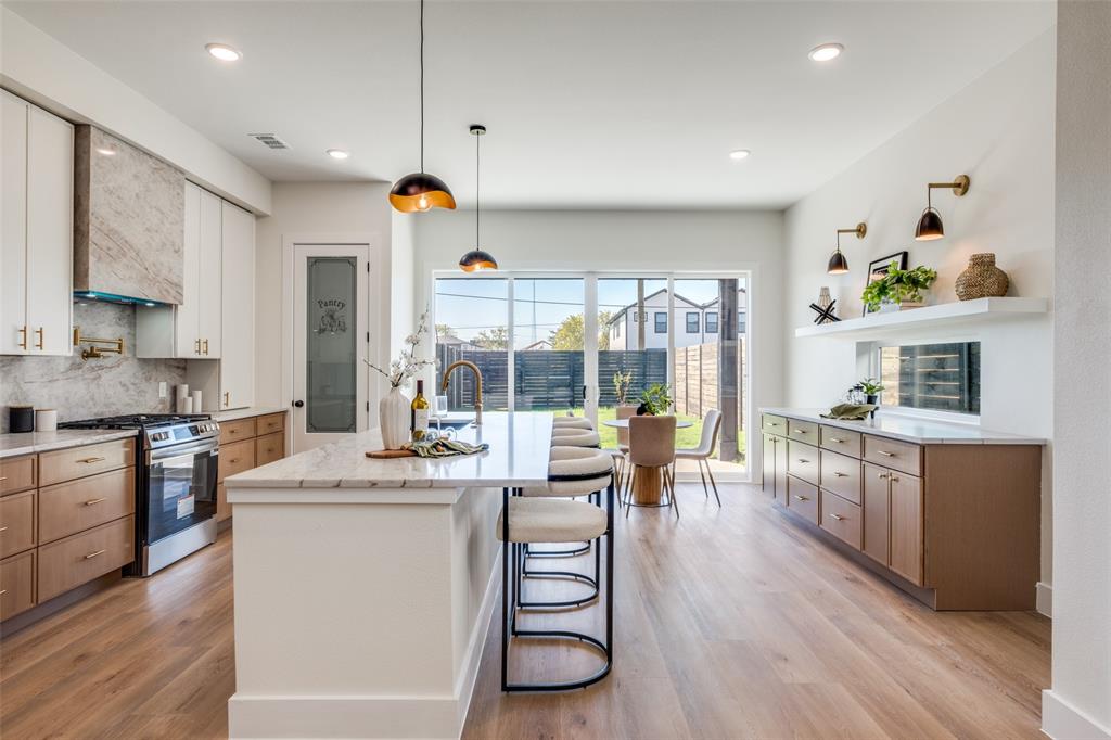 a kitchen with counter top space and wooden floor