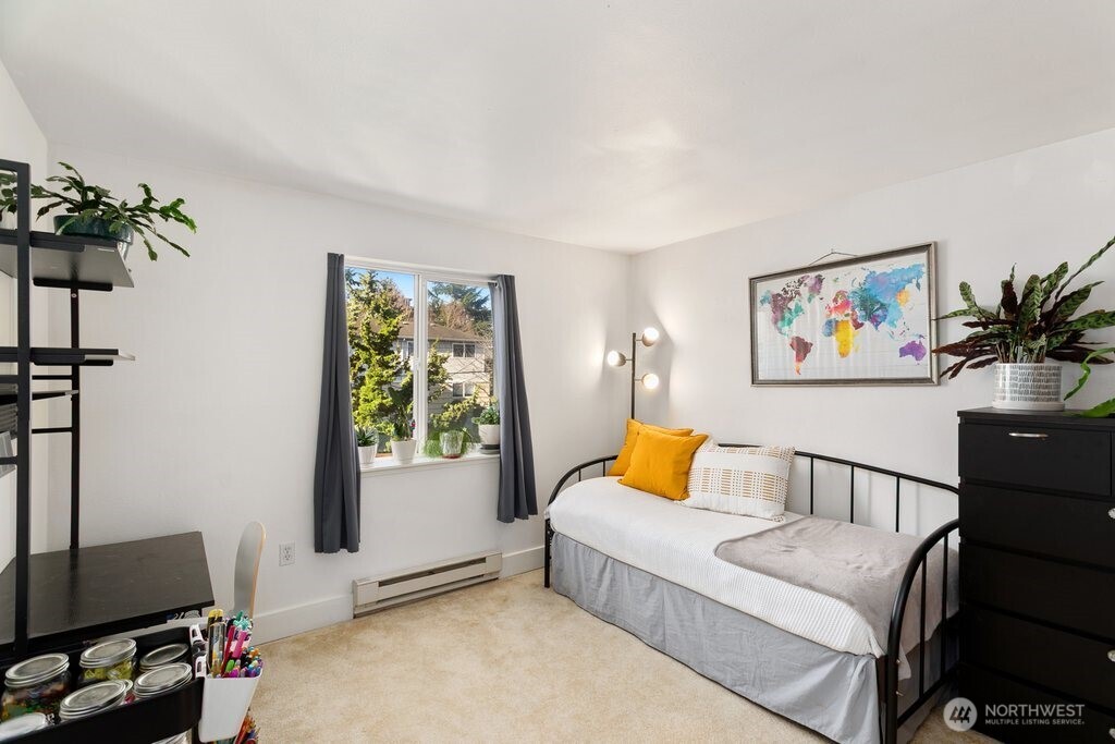 4831 Fauntleroy Way Southwest, Unit 206 Seattle, WA 98116 - Photo 11 of 21 a bedroom with furniture and a potted plant