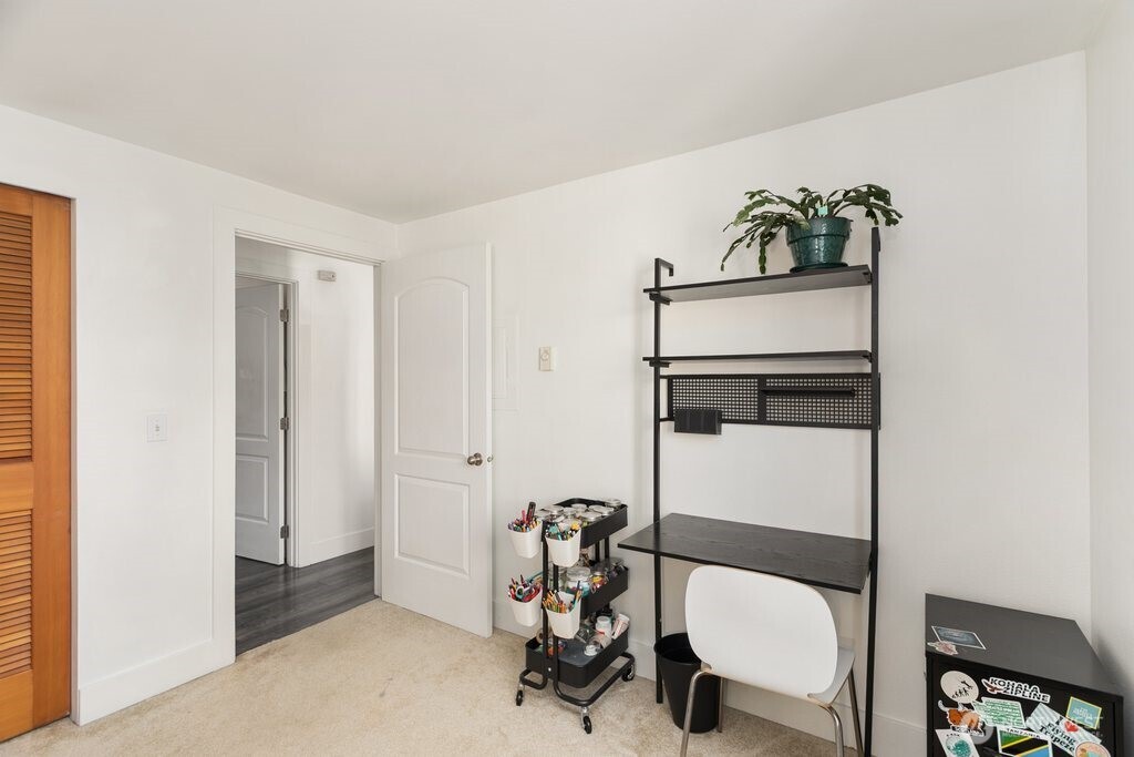 4831 Fauntleroy Way Southwest, Unit 206 Seattle, WA 98116 - Photo 12 of 21 a bathroom with a toilet a sink and mirror