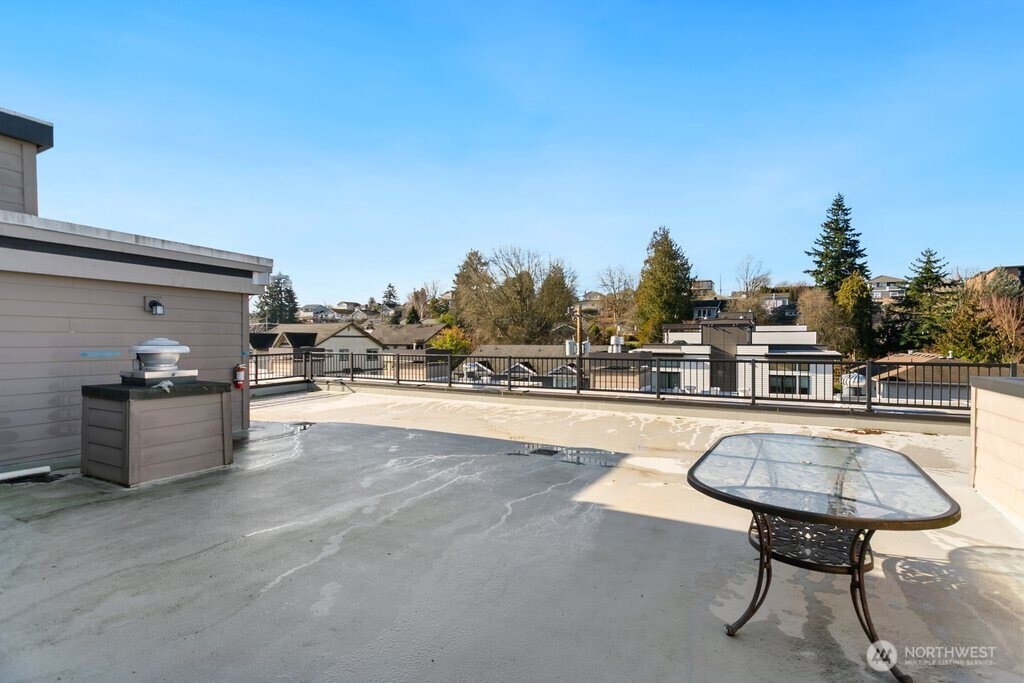 4831 Fauntleroy Way Southwest, Unit 206 Seattle, WA 98116 - Photo 19 of 21 a view of a swimming pool with outdoor seating and plants