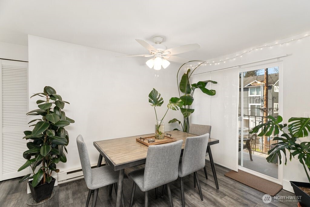 4831 Fauntleroy Way Southwest, Unit 206 Seattle, WA 98116 - Photo 6 of 21 a dining room with furniture potted plants and wooden floor